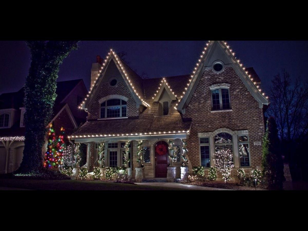 House decorated with Christmas lights at night.