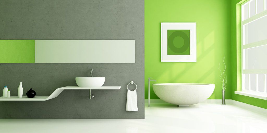A bathroom with green walls and a white tub