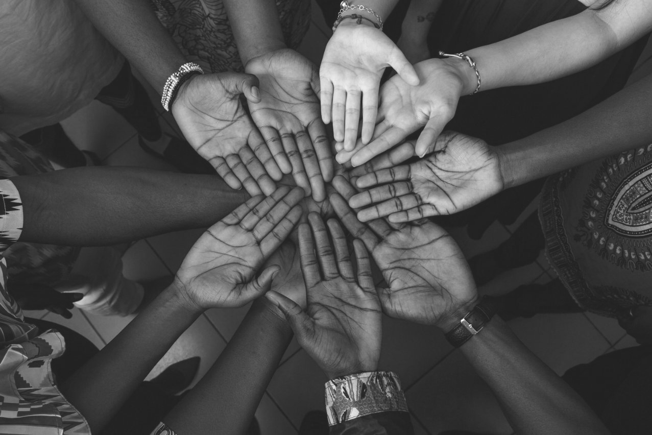 group of hands joined together in circle