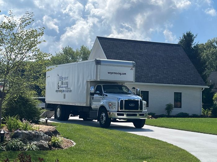 A weyer moving truck is parked in a parking lot