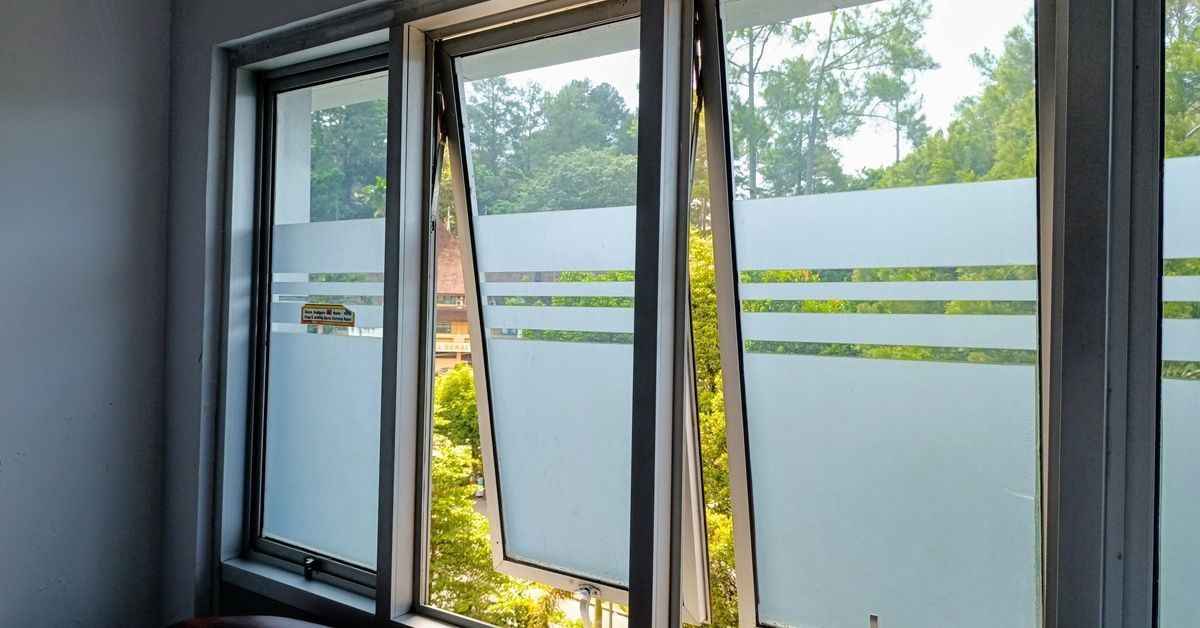A row of windows with half of each pane frosted tint with a minimalist design, so only a small portion of the outdoors is visible.