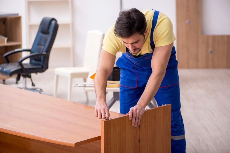 Carpenter installing custom wood built-in shelving.