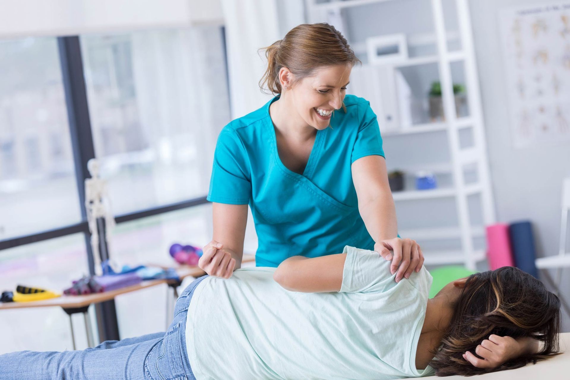 Chiropractor adjusts female patient — Foley, AL — A Better Way Health Food Store DR. Mary Sabal