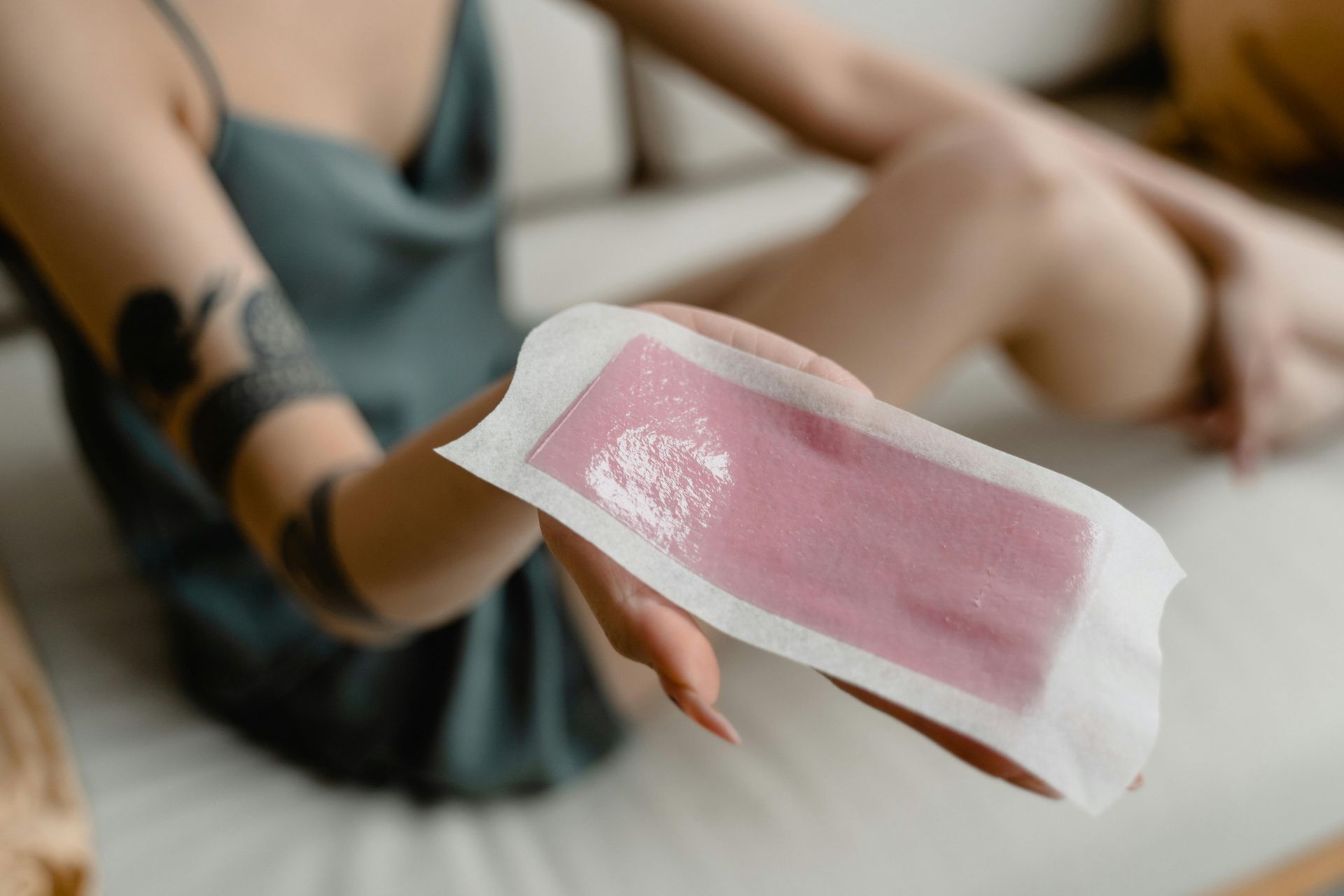 A woman is sitting on a couch holding a piece of wax.