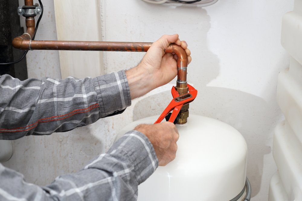 Gasfitter Connecting A Gas Cylinder — Plumbers & Gasfitters in the Darling Downs