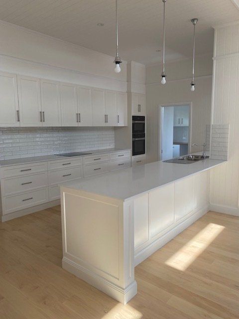 Plumber Fixing Sink Pipe In The Bathroom — Plumbers & Gasfitters in the Darling Downs