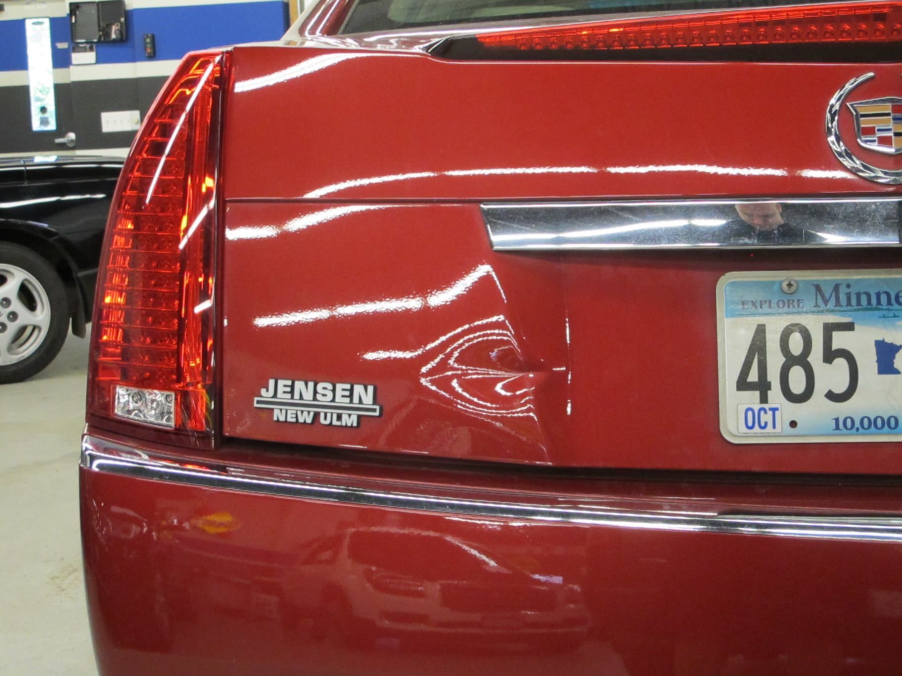 A red car with a minnesota license plate 485