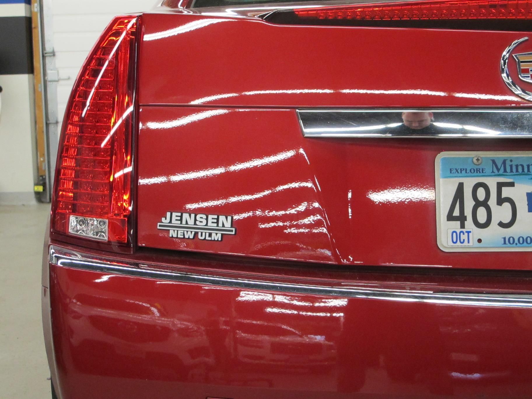 A red car with a minnesota license plate 485