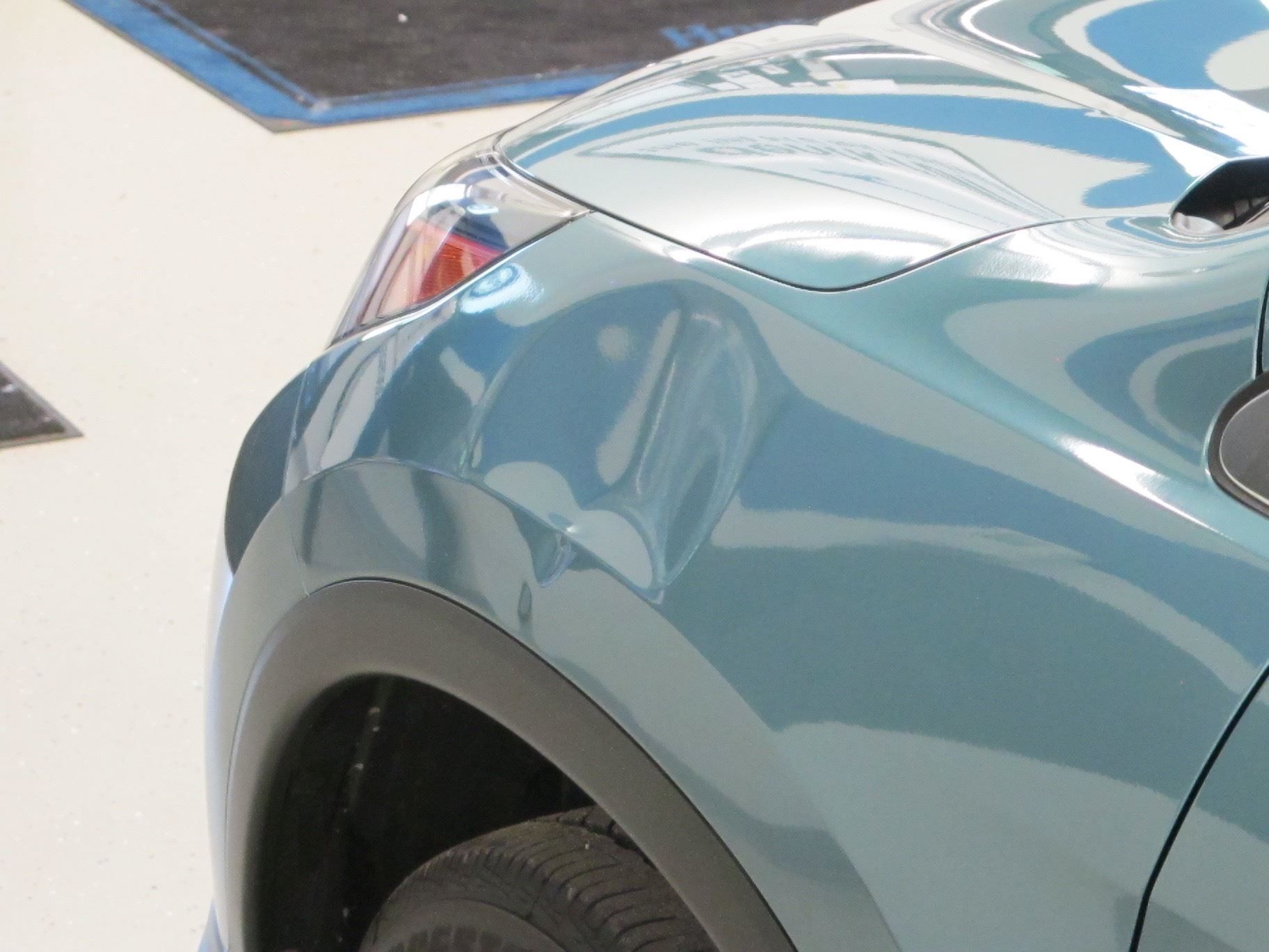 A close up of the front of a blue car