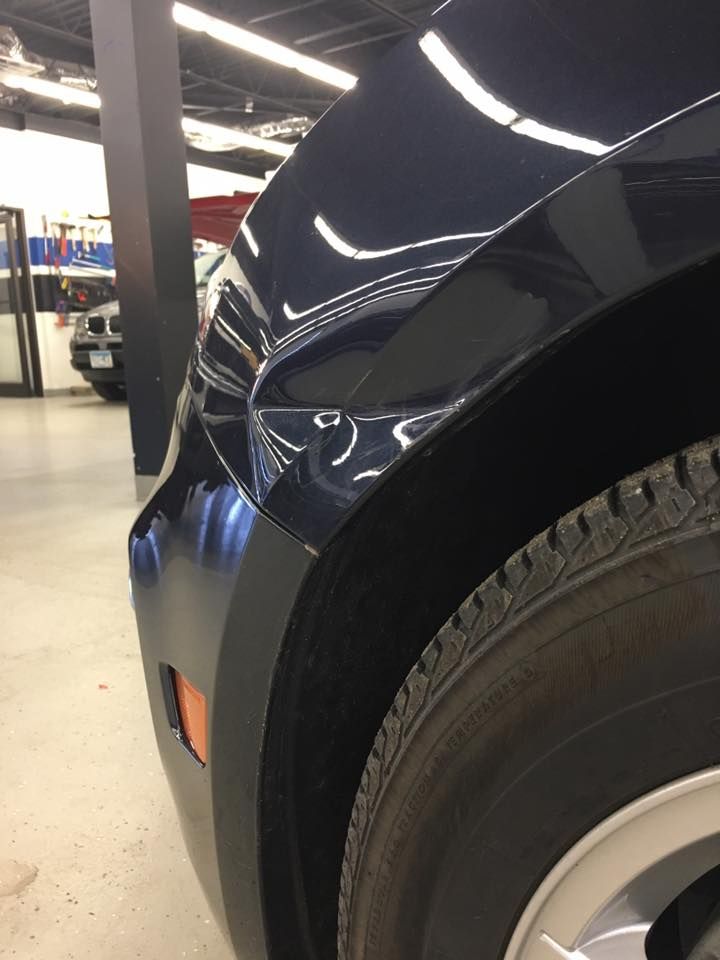 A close up of a car 's fender and tire