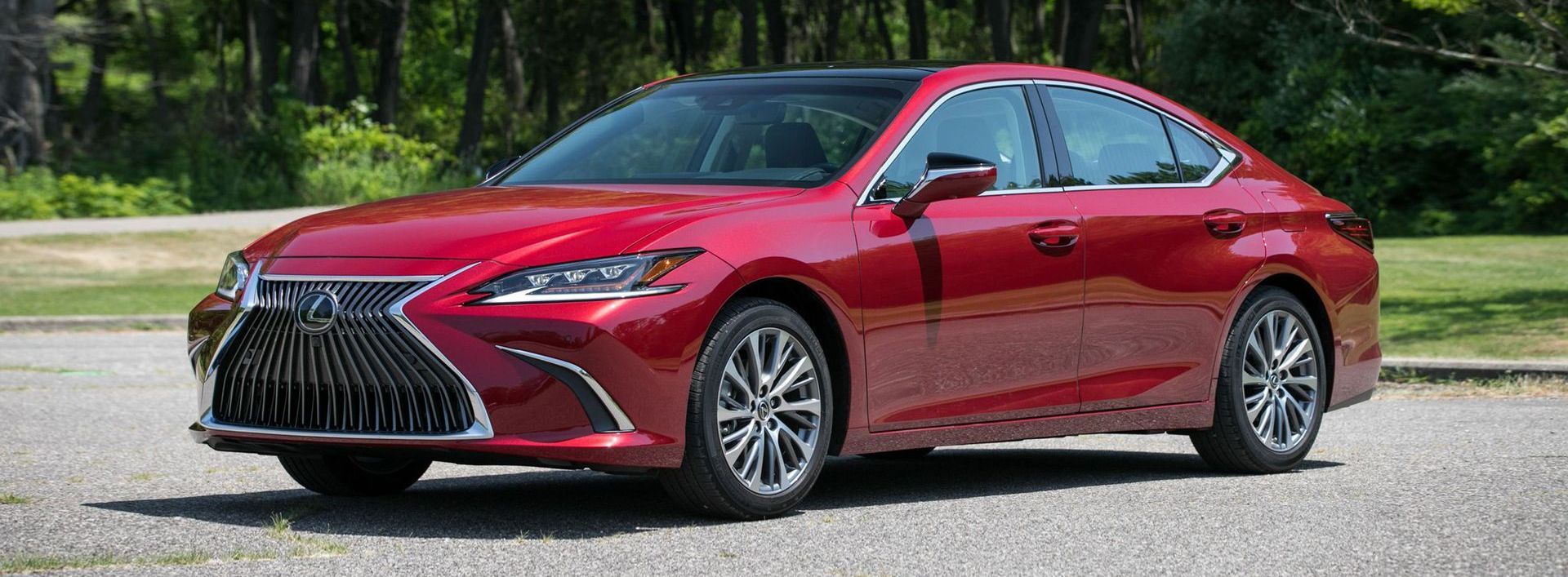 A red lexus es 350 is parked on the side of the road.