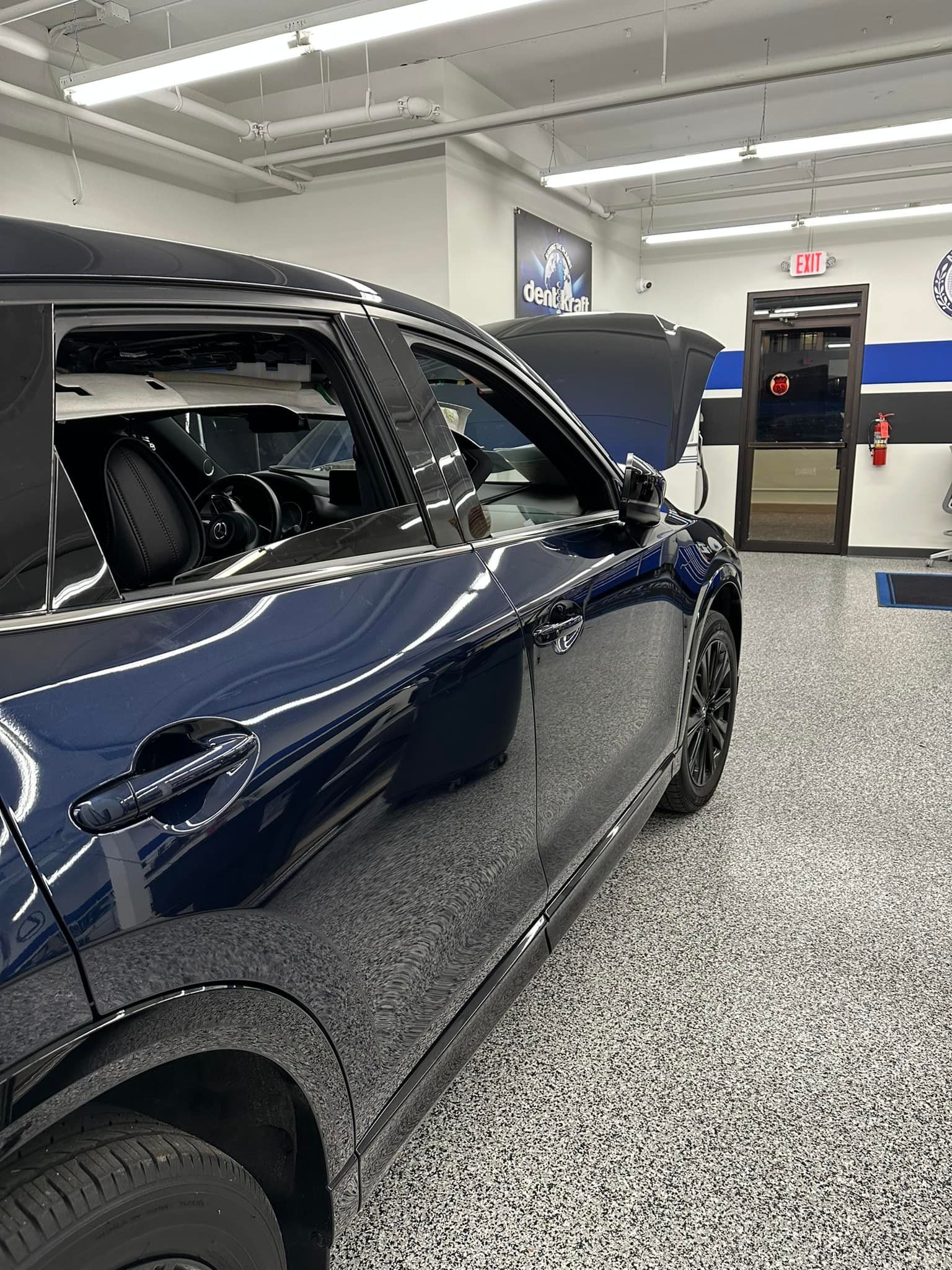 A black car is parked in a garage.