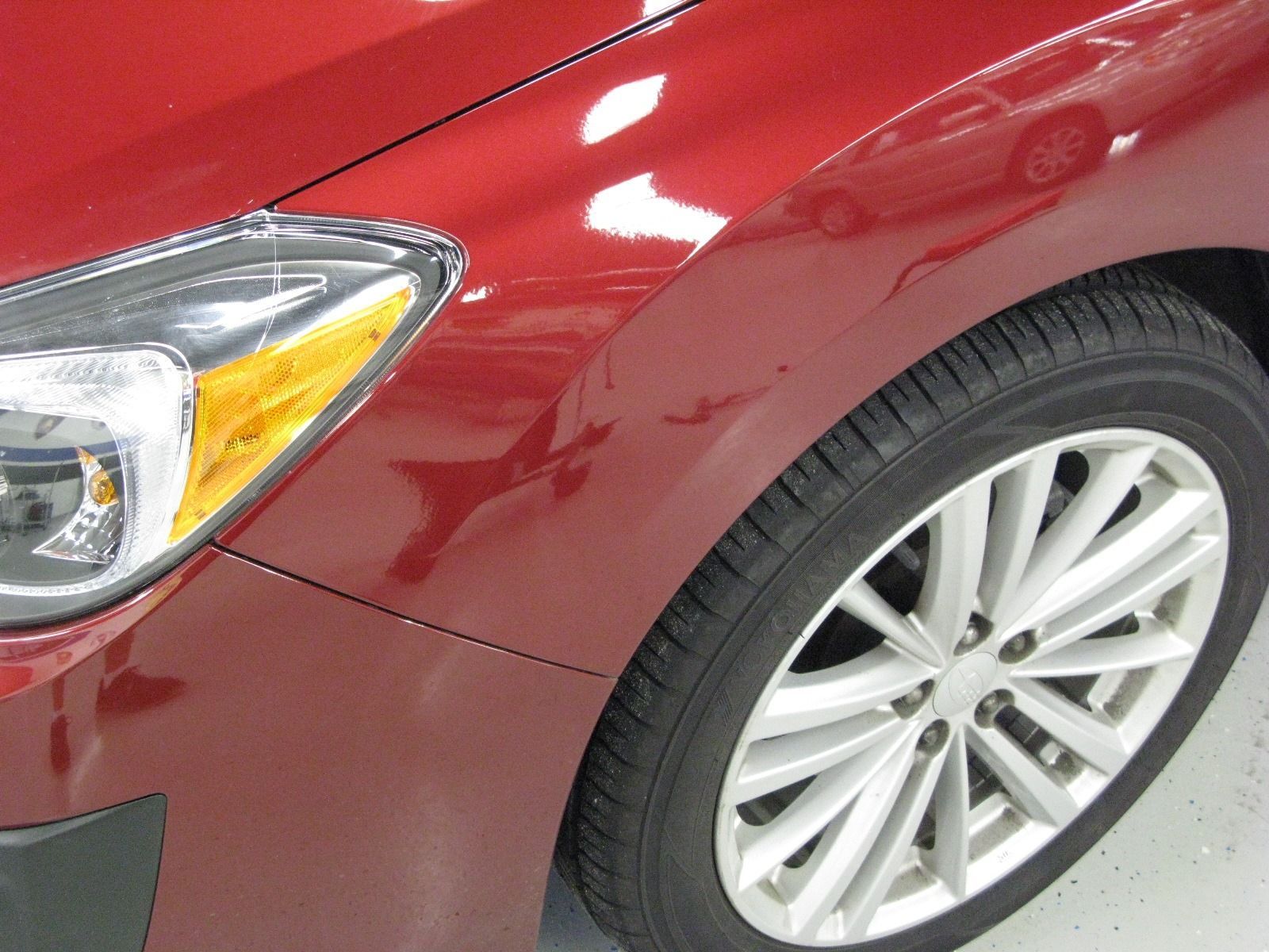 A close up of a red car with silver wheels