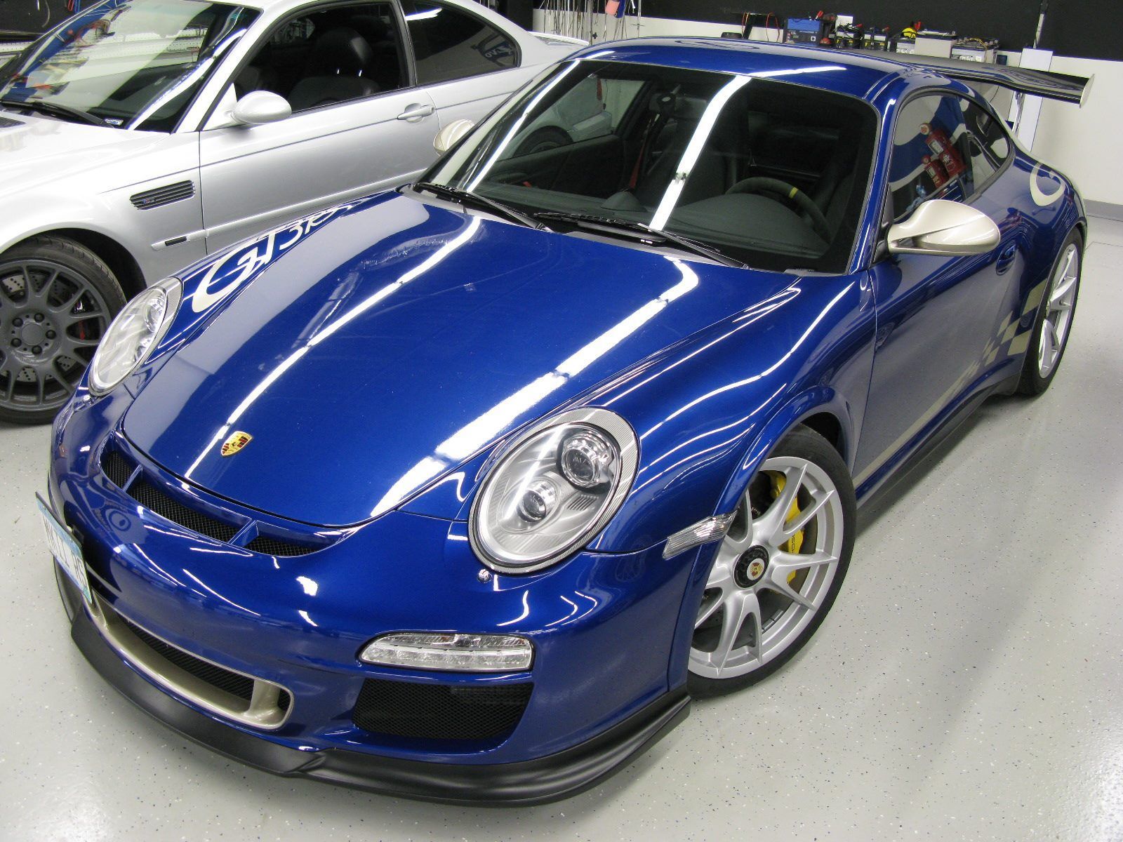 A blue car is parked next to a silver car