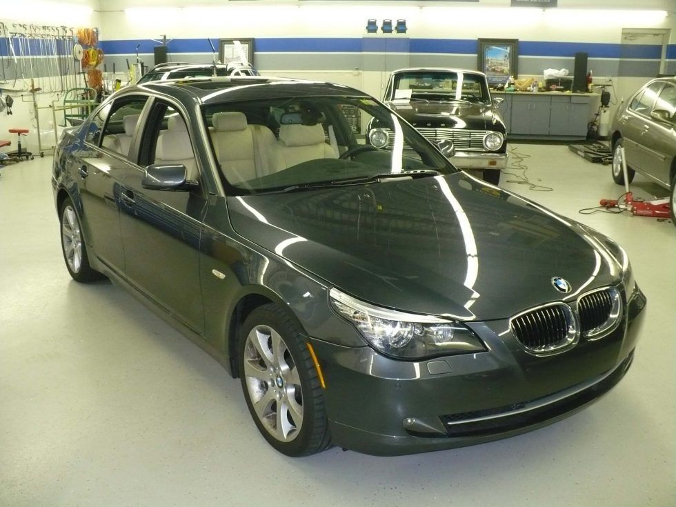 A gray bmw is parked in a garage