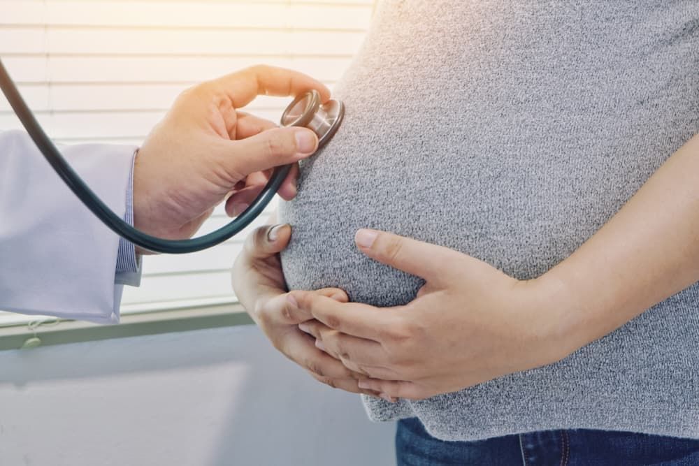 A Pregnant Woman is Being Examined by a Doctor With a Stethoscope — Life24 Health Bowen Therapy In Lavington, NSW