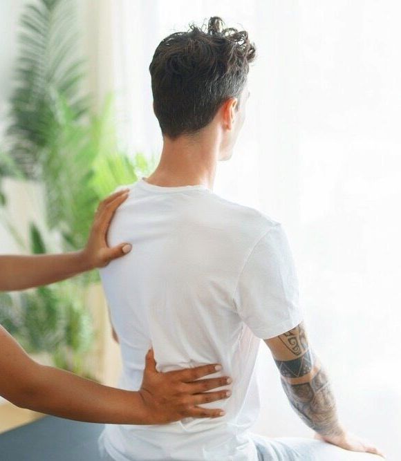 A Woman in a Green Shirt is Getting a Massage on Her Leg — Life24 Health Bowen Therapy In Lavington, NSW