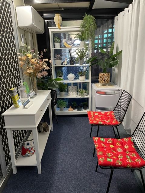 A waiting room with two chairs and a book shelf — Life24 Health Bowen Therapy In Lavington, NSW