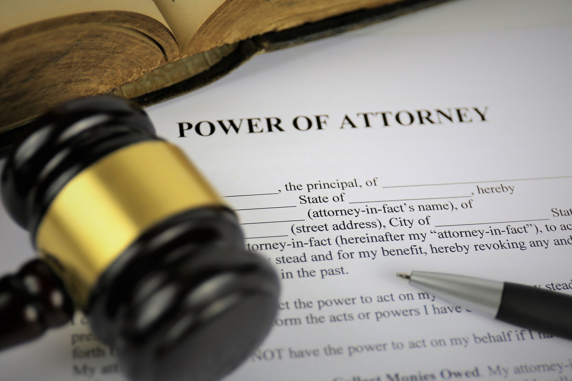 A gavel, pen, and document titled 