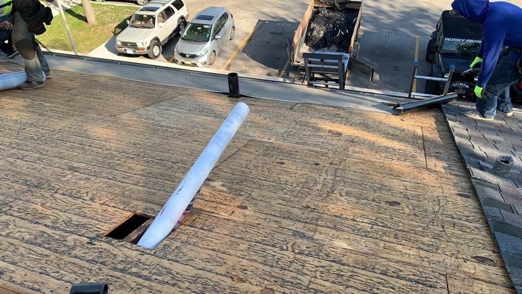 A group of people are working on a roof.