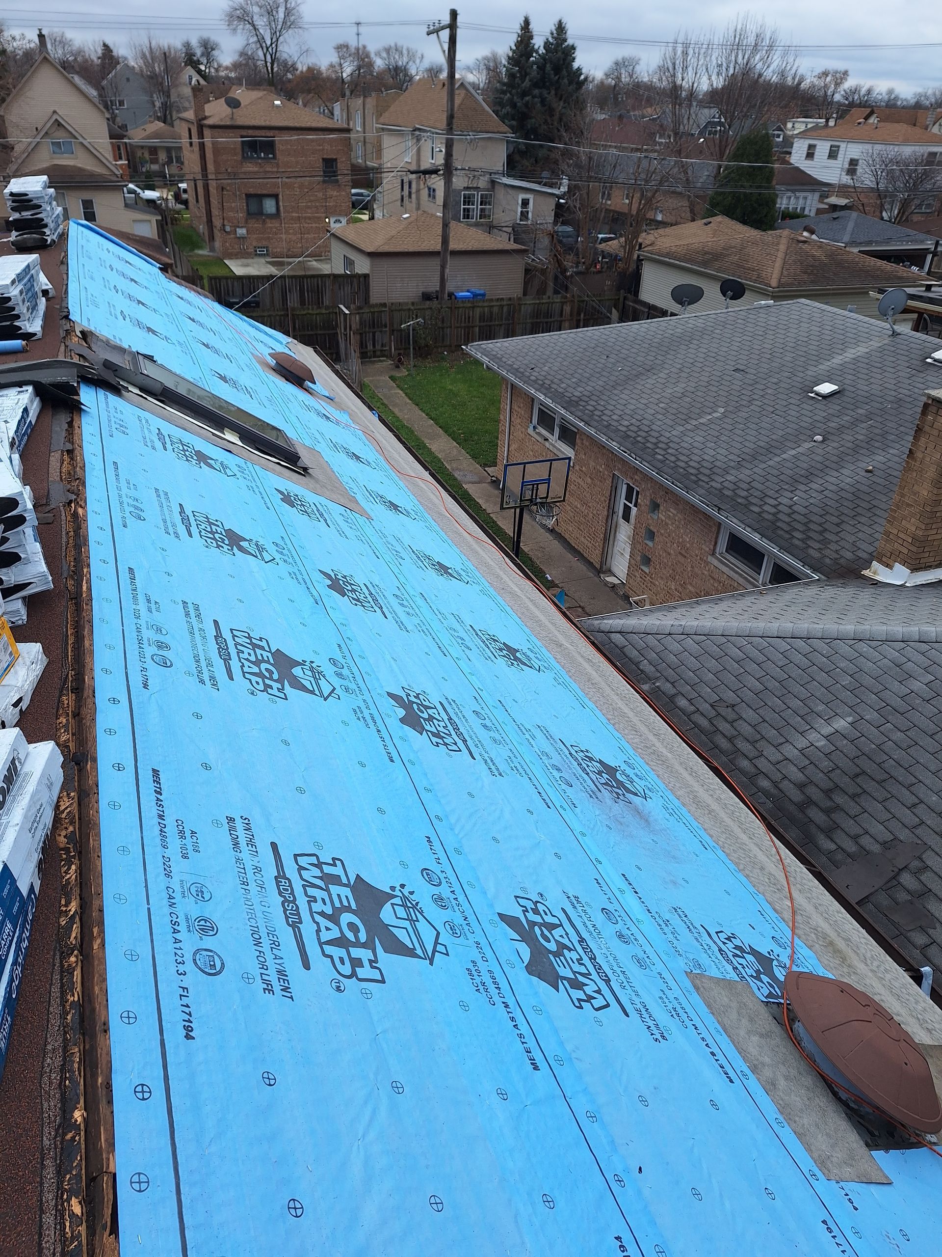 The roof of a house is covered in blue foam.