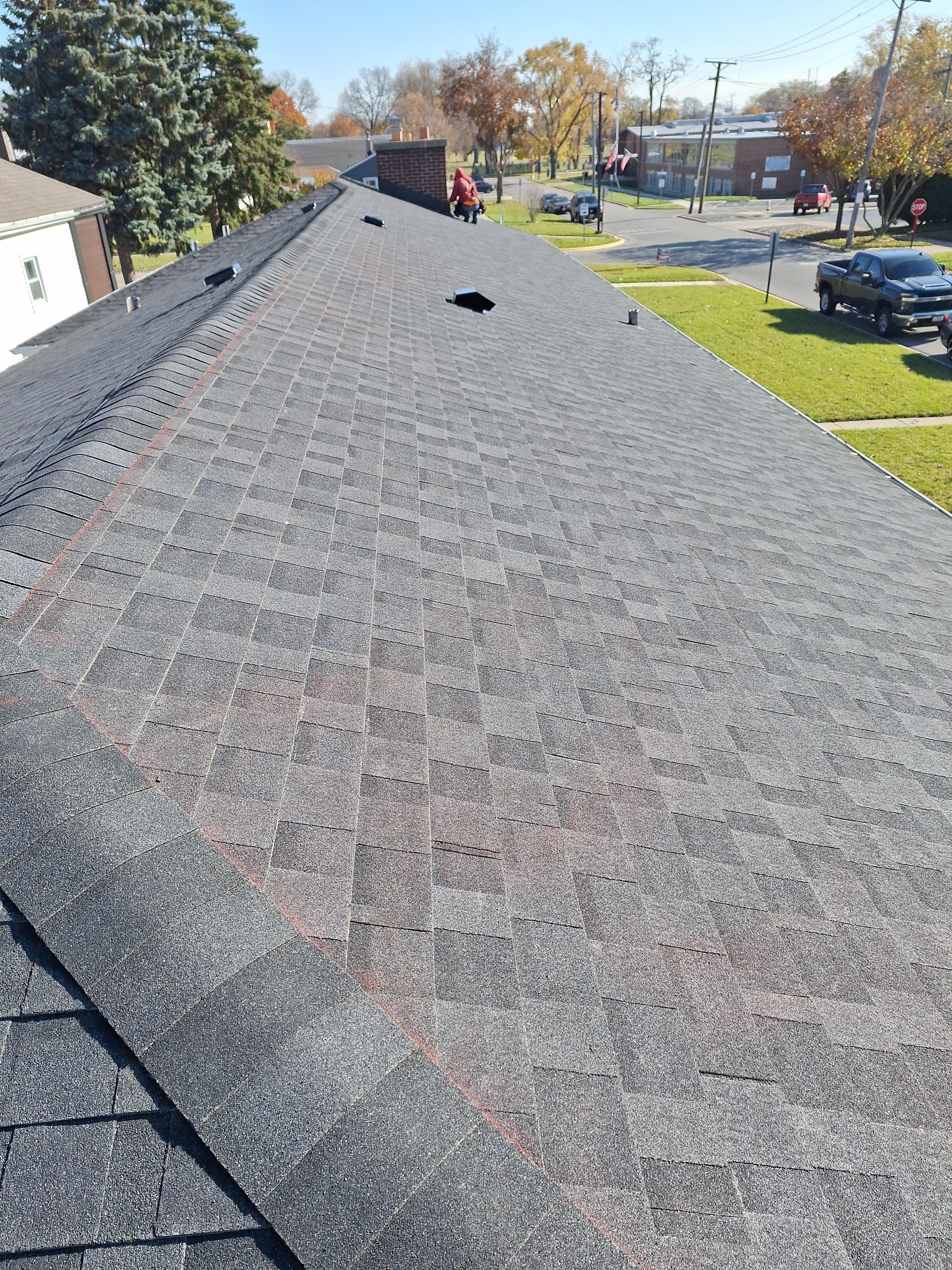 A black truck is parked on the roof of a building.