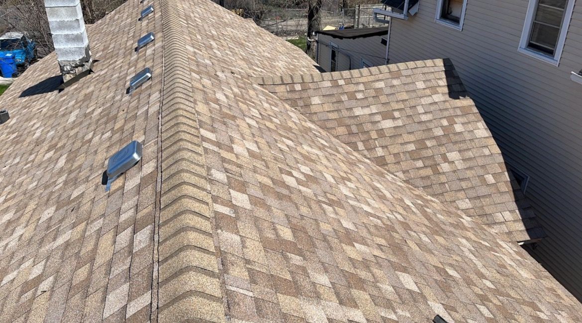 A close up of a roof with a chimney on it.
