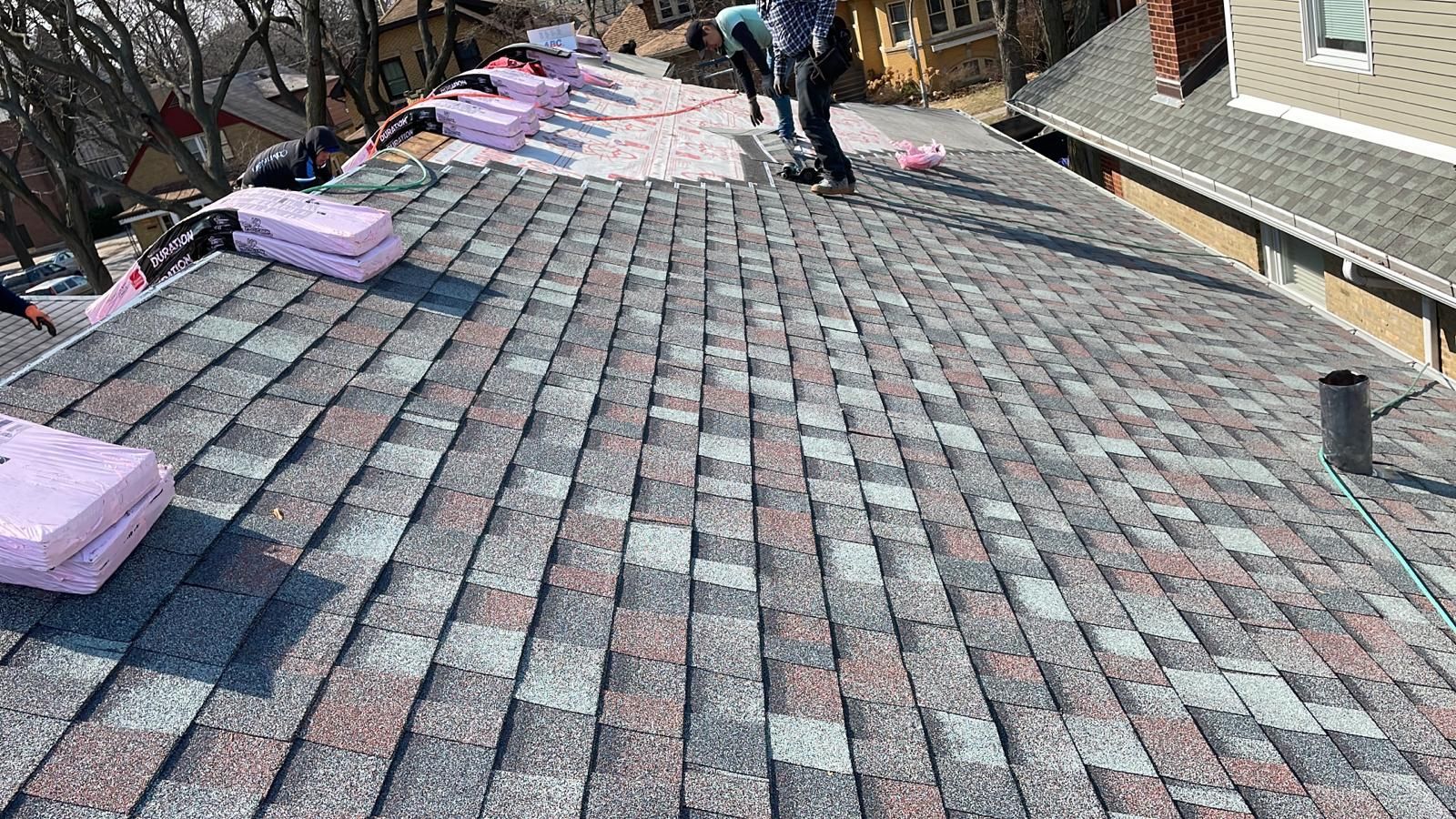 A group of people are working on a roof.