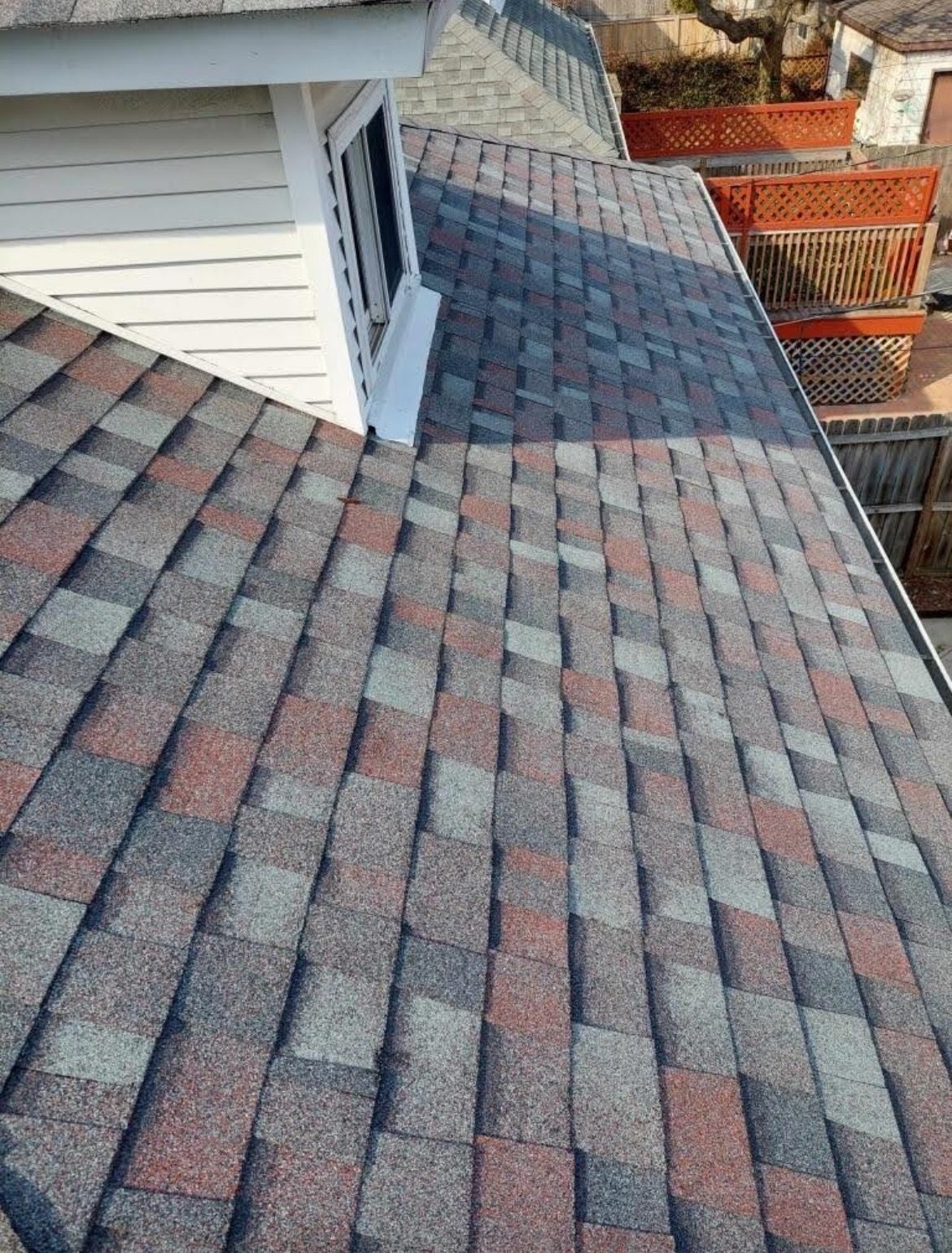 A close up of a roof with shingles on a house.