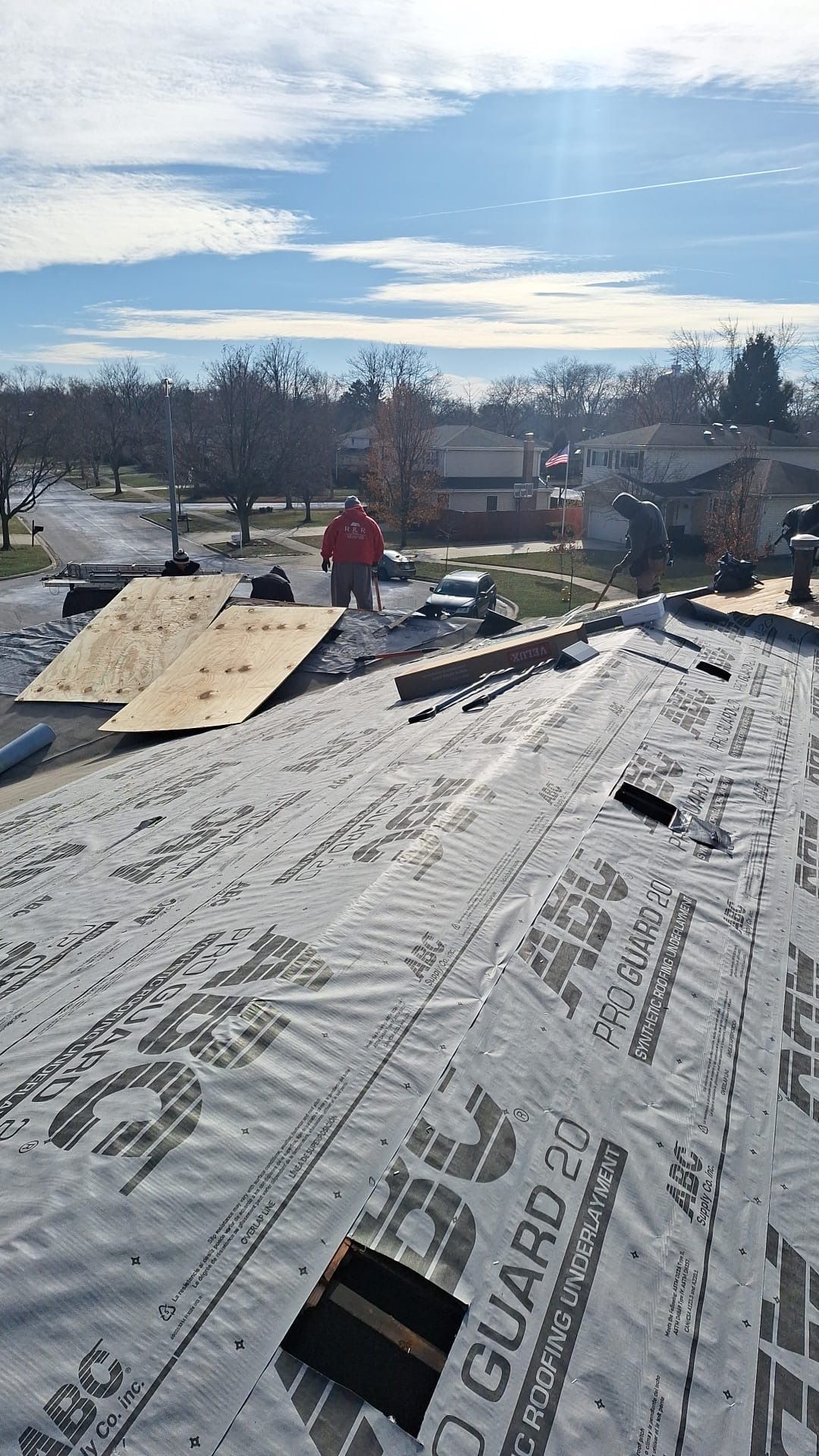 A man is working on the roof of a house.