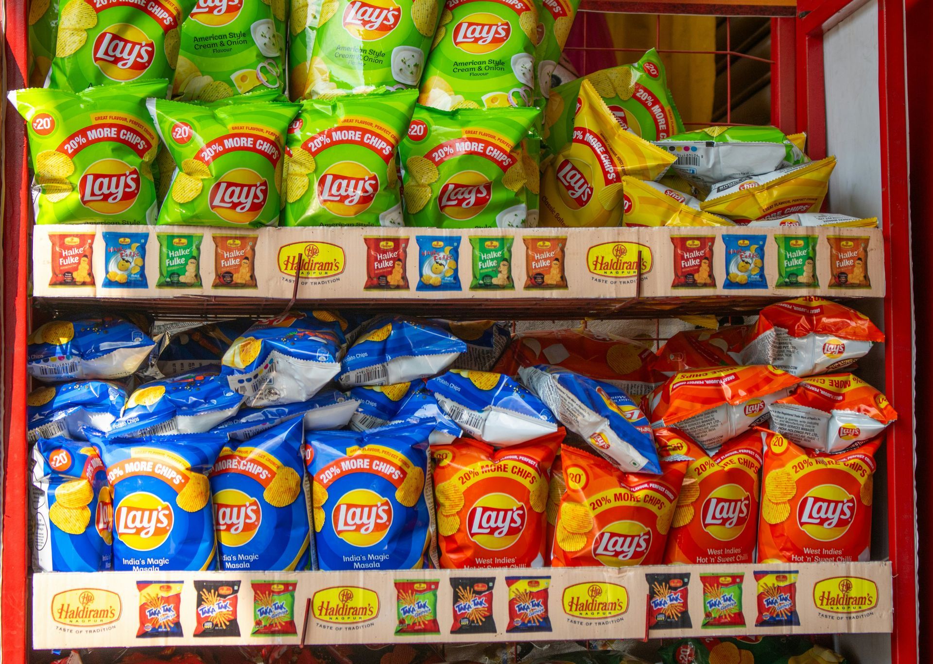 Shelf stocked with colorful Lay’s potato chip bags in a store display