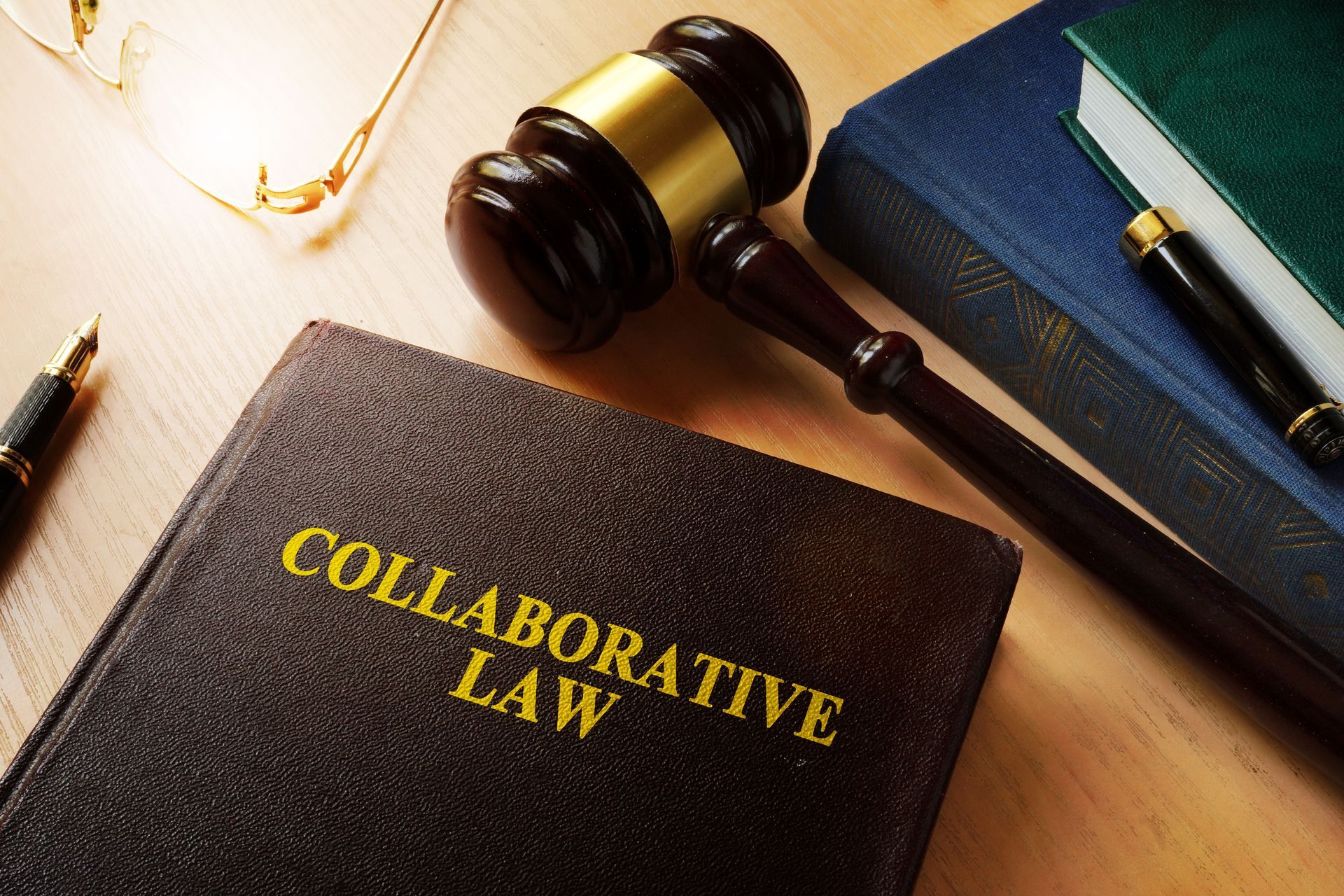 Collaborative law on a desk and gavel.