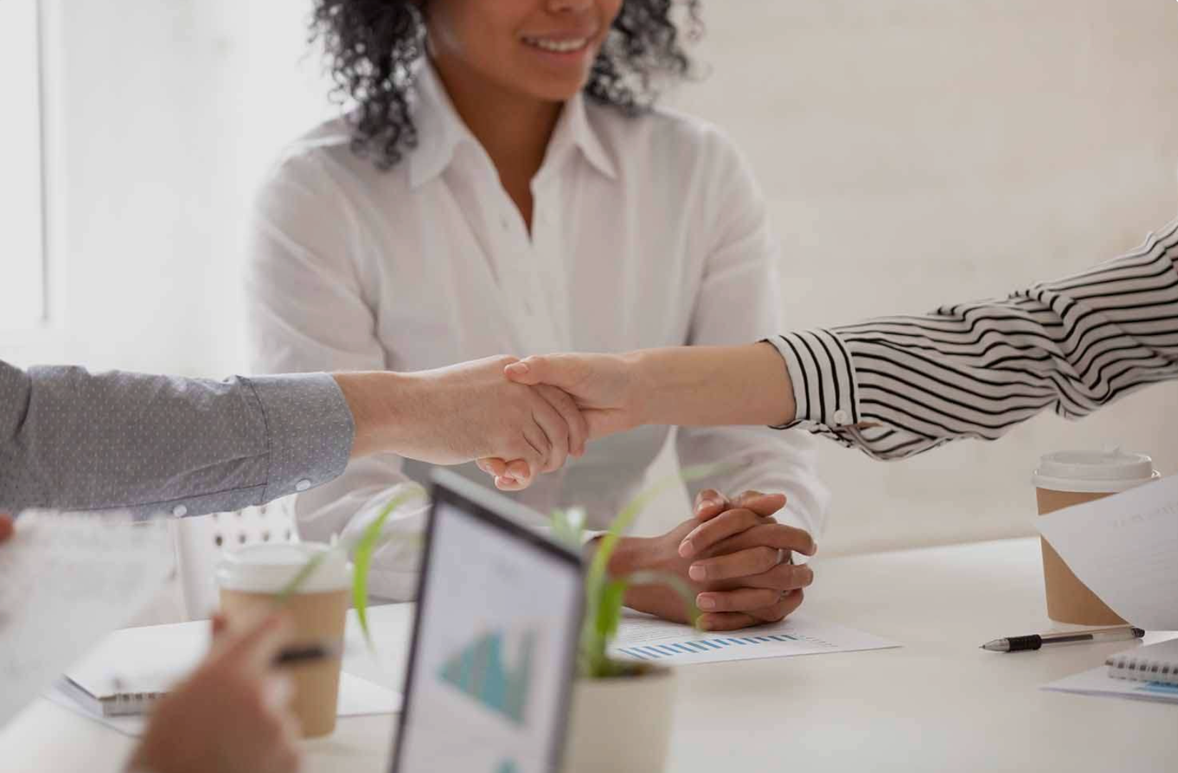 Court mediation meeting with legal documents, gavel, and scales of justice on a wooden desk.