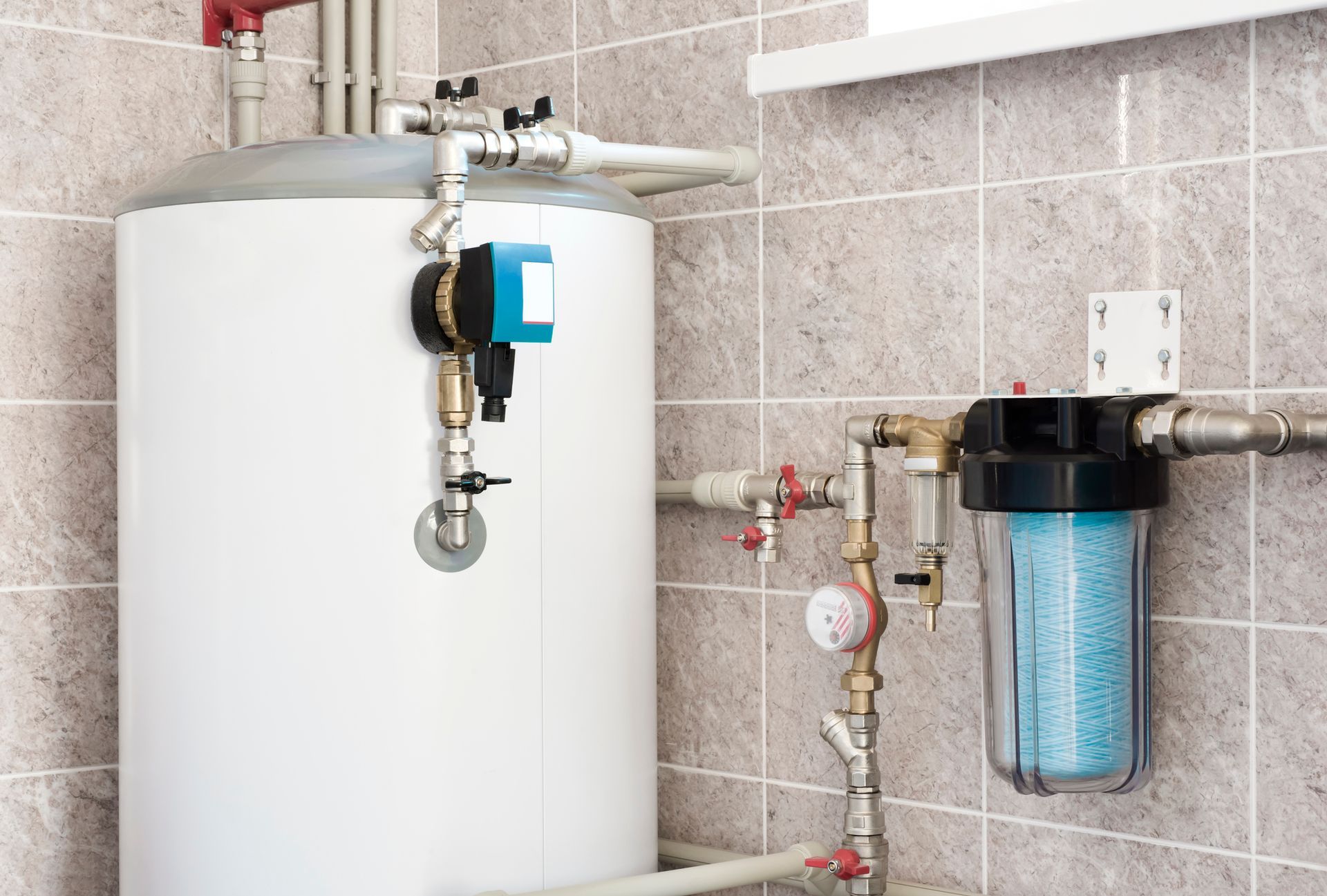 Water heater and filtration system against tiled wall.