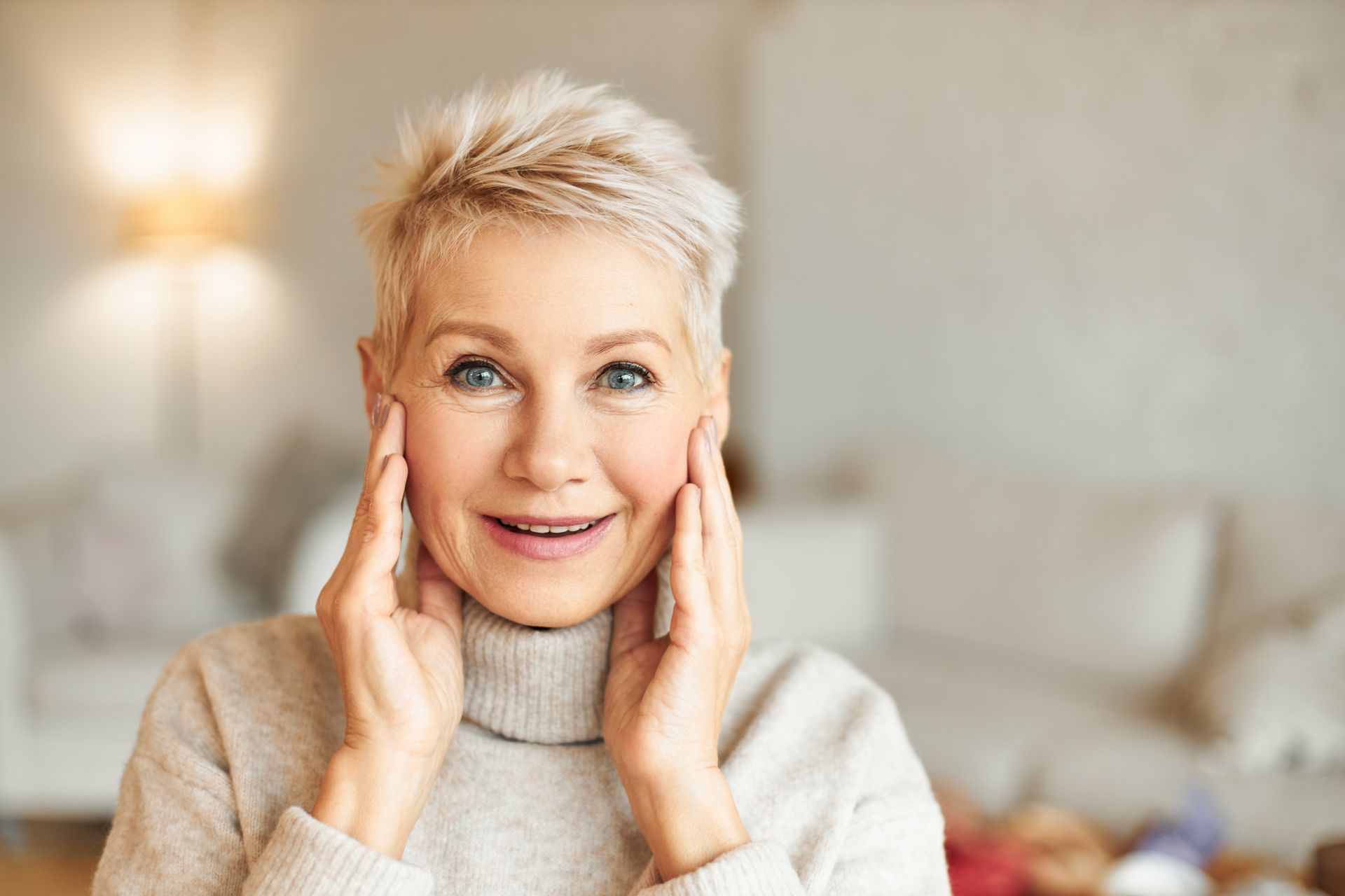 a woman with her eyes closed is touching her face with her hand .