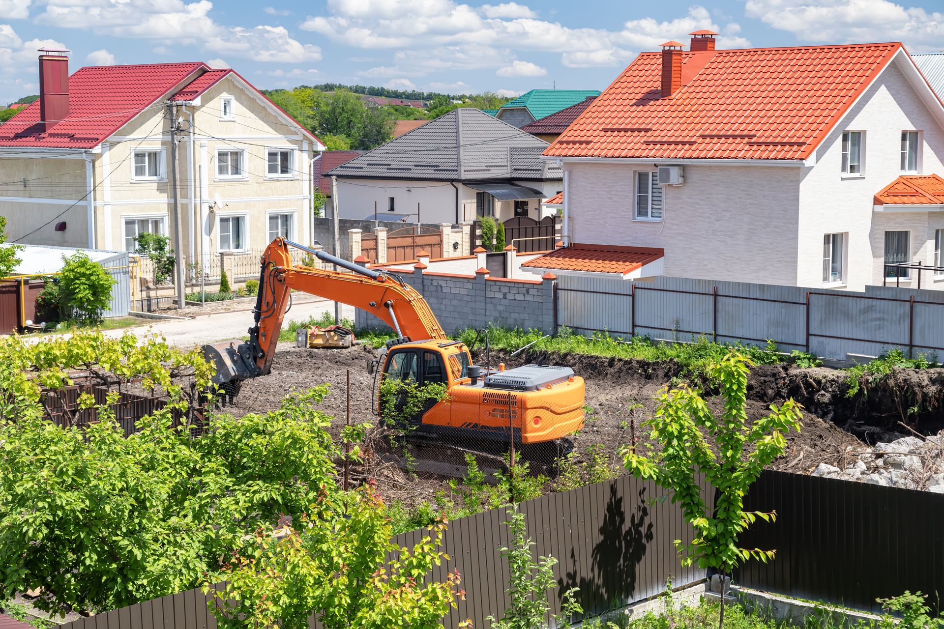 Excavator work on clearing the territory of the land plot for the construction of a cottage.