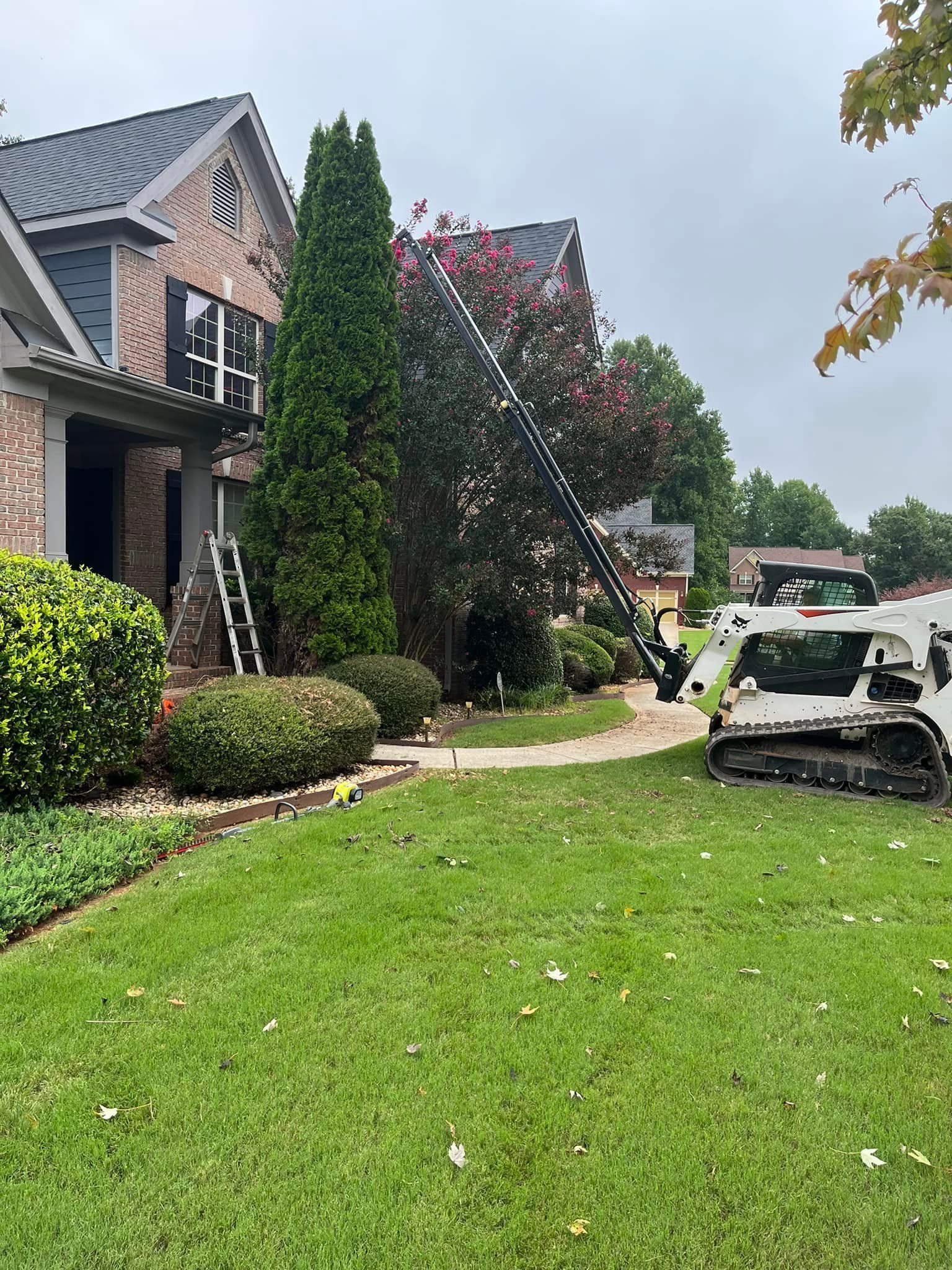 A house with a bulldozer parked in front of it.
