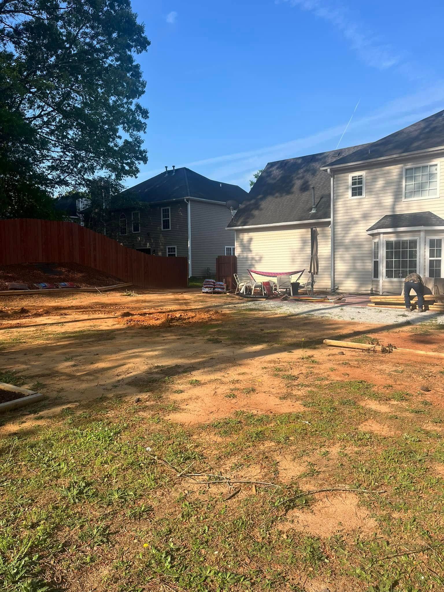 A house is being built in the middle of a dirt field.
