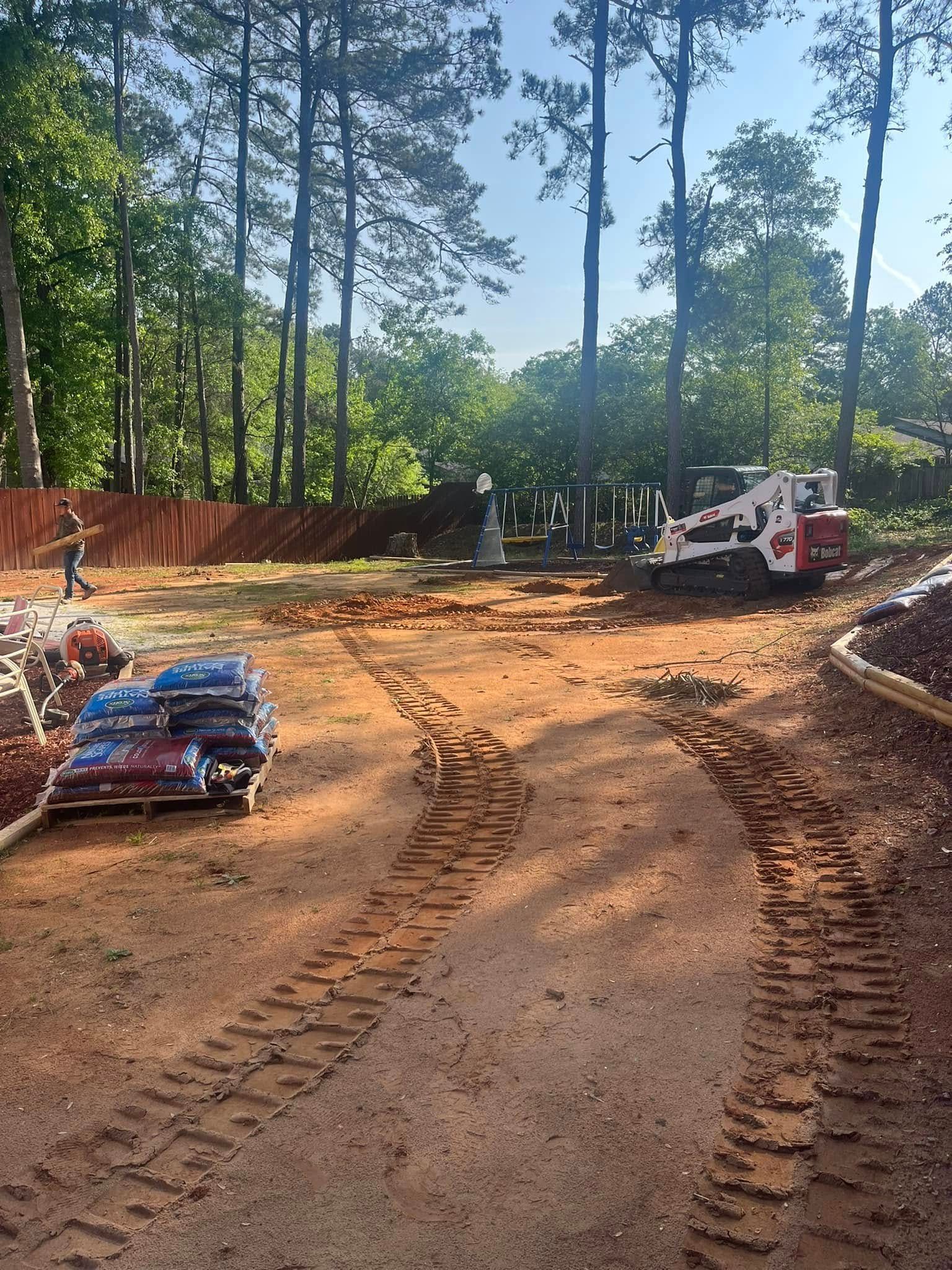 A construction site with a bulldozer and bags of dirt.