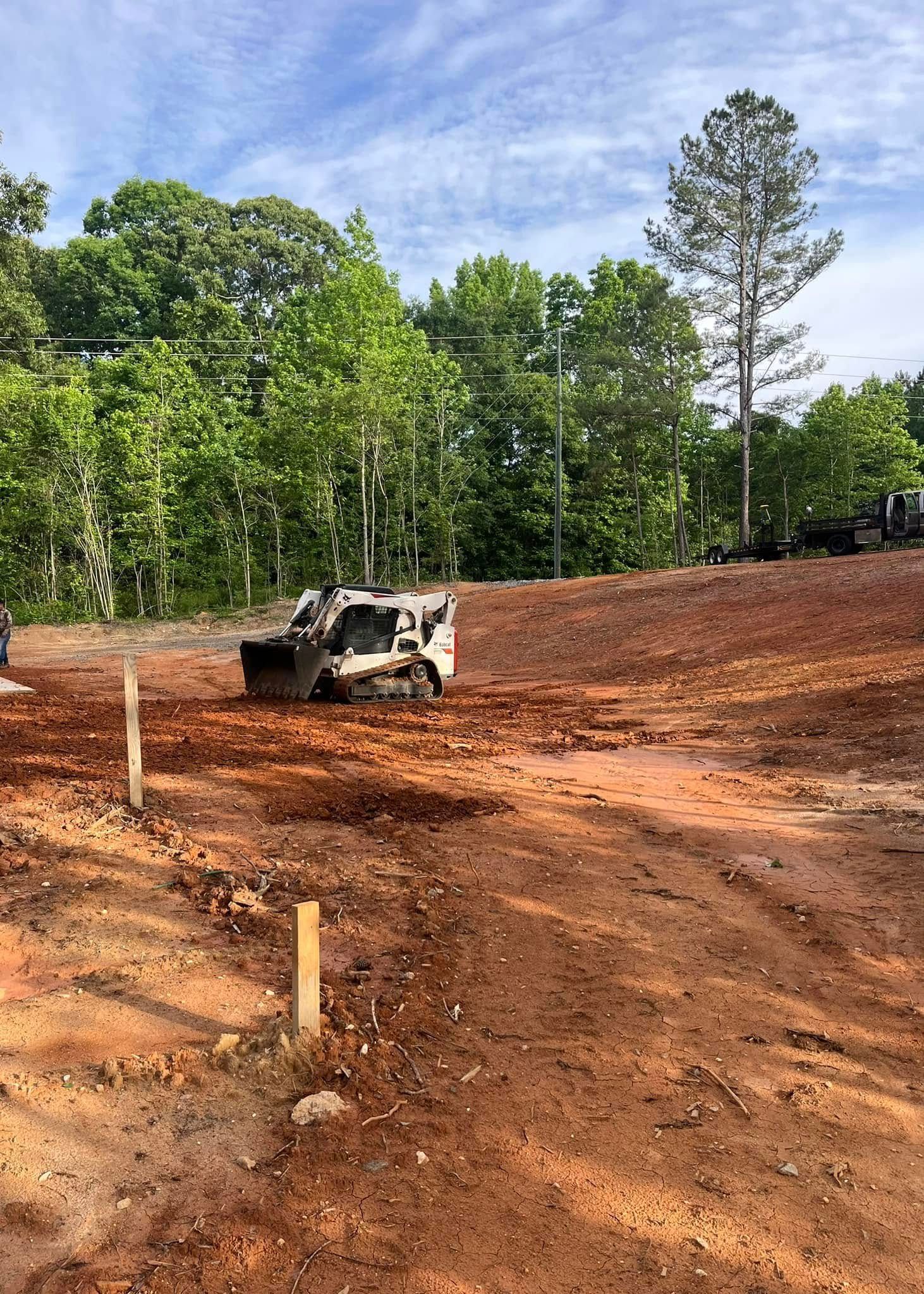 A bulldozer is sitting on top of a dirt hill.