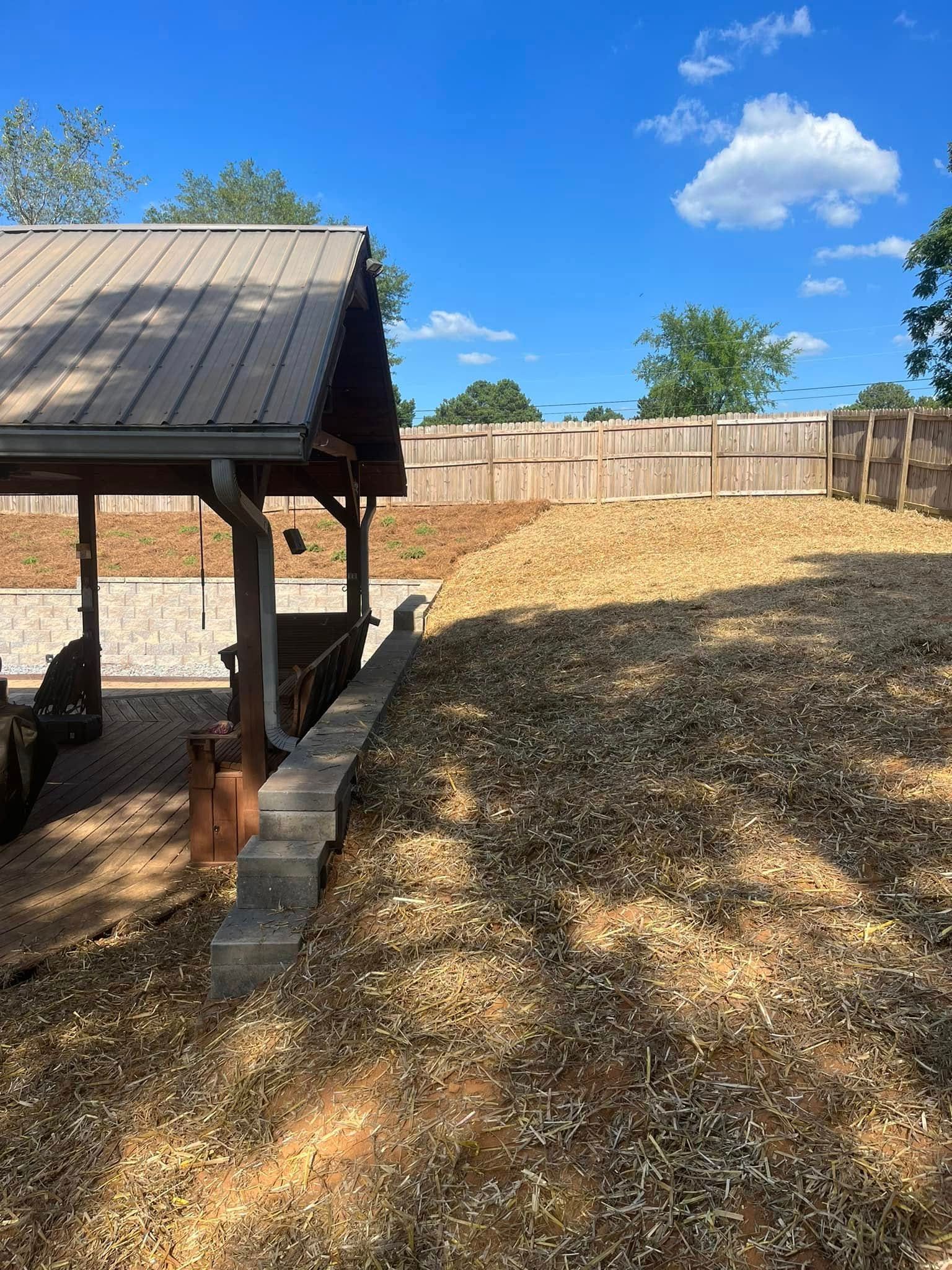 There is a fence in the background and a pavilion in the foreground.
