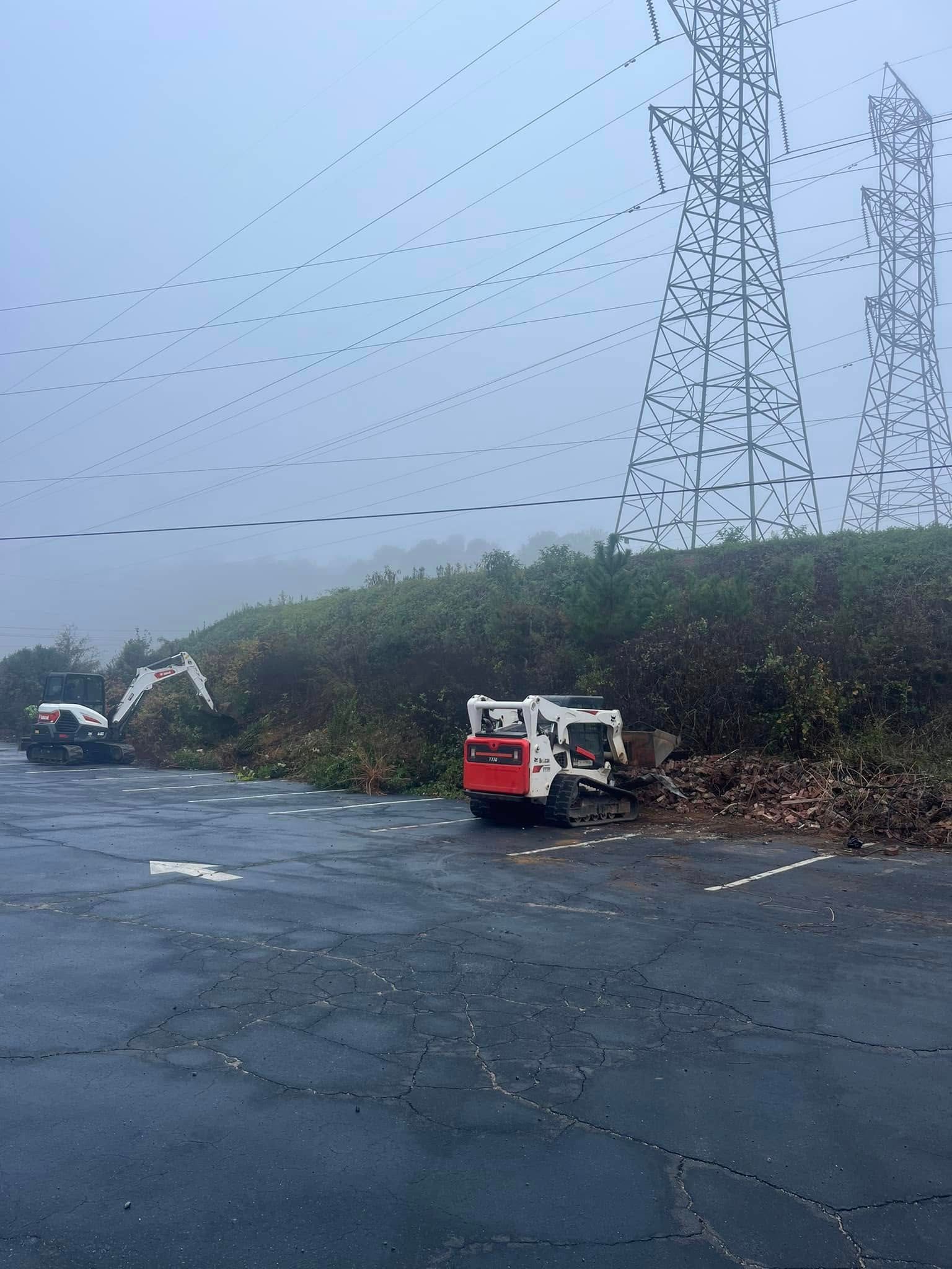 A red and white truck is parked in a parking lot with power lines in the background.