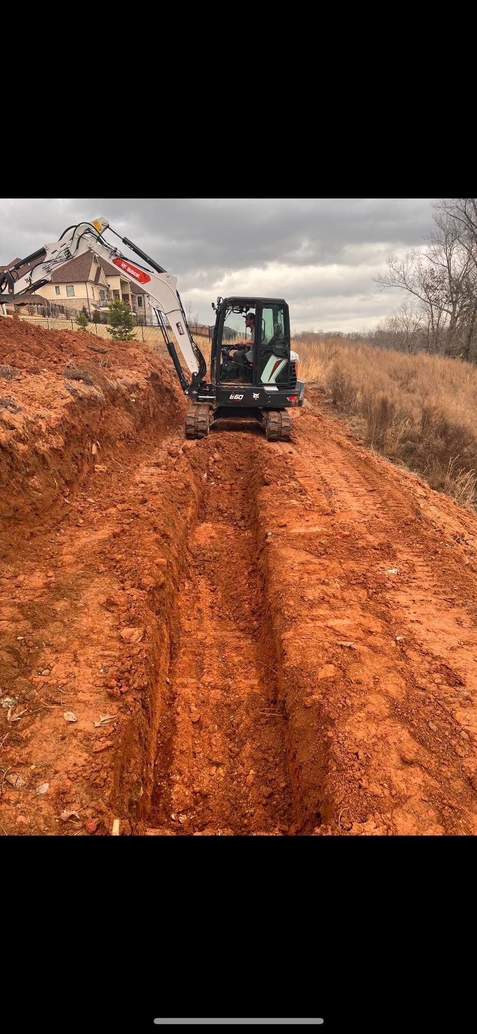 A bulldozer is driving down a dirt road.