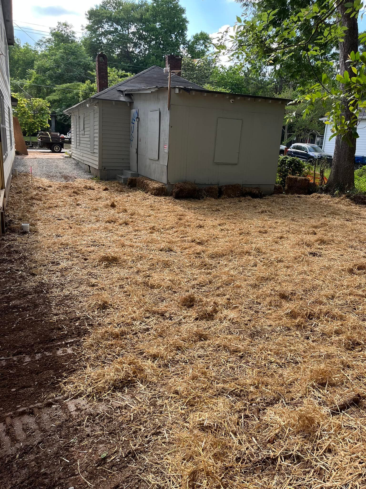 A house is sitting on top of a pile of wood chips.