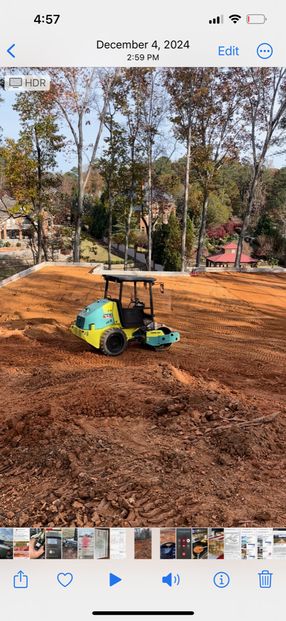 A bulldozer is moving dirt in a field.