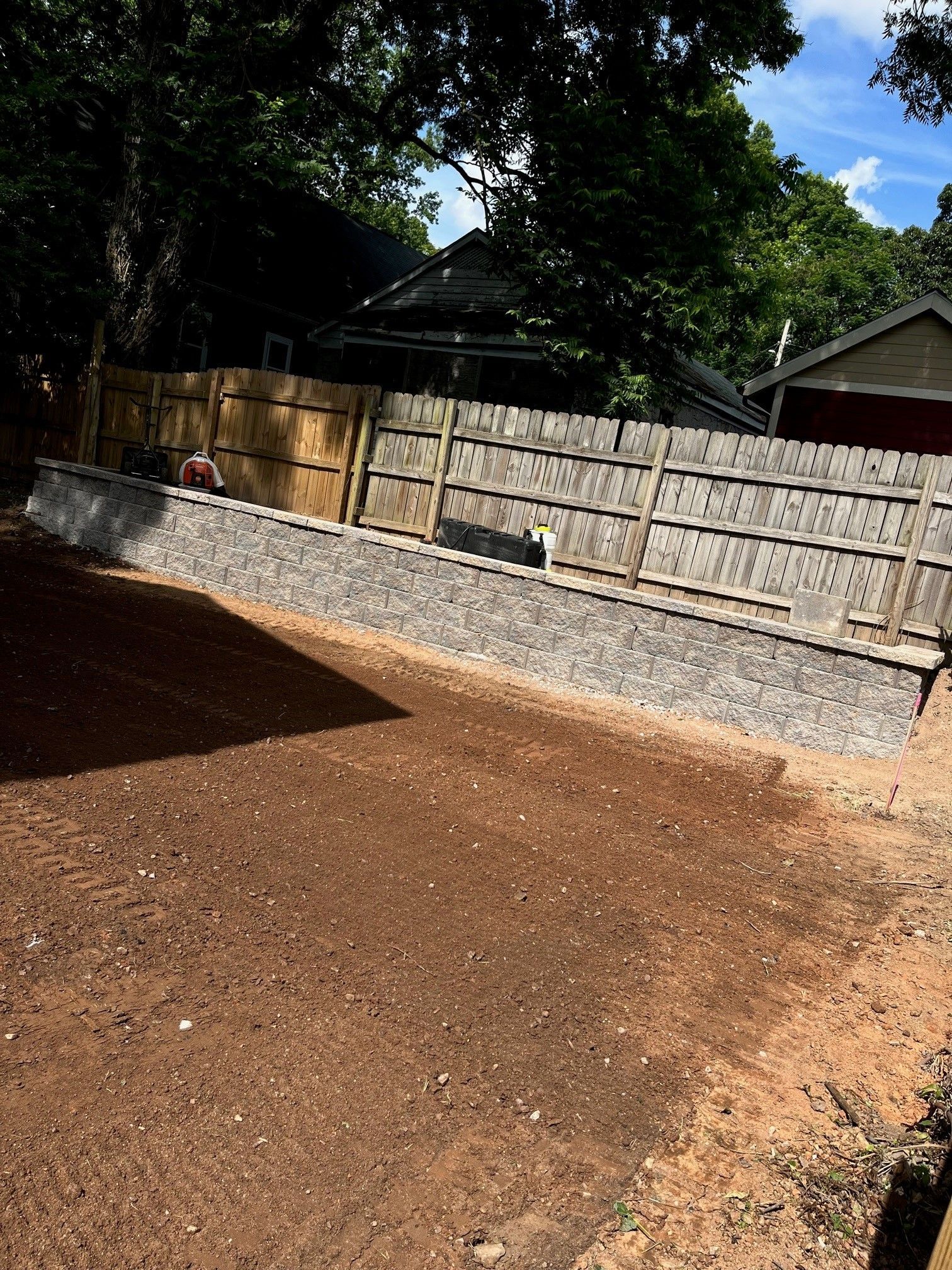 A fence is being built in the backyard of a house.