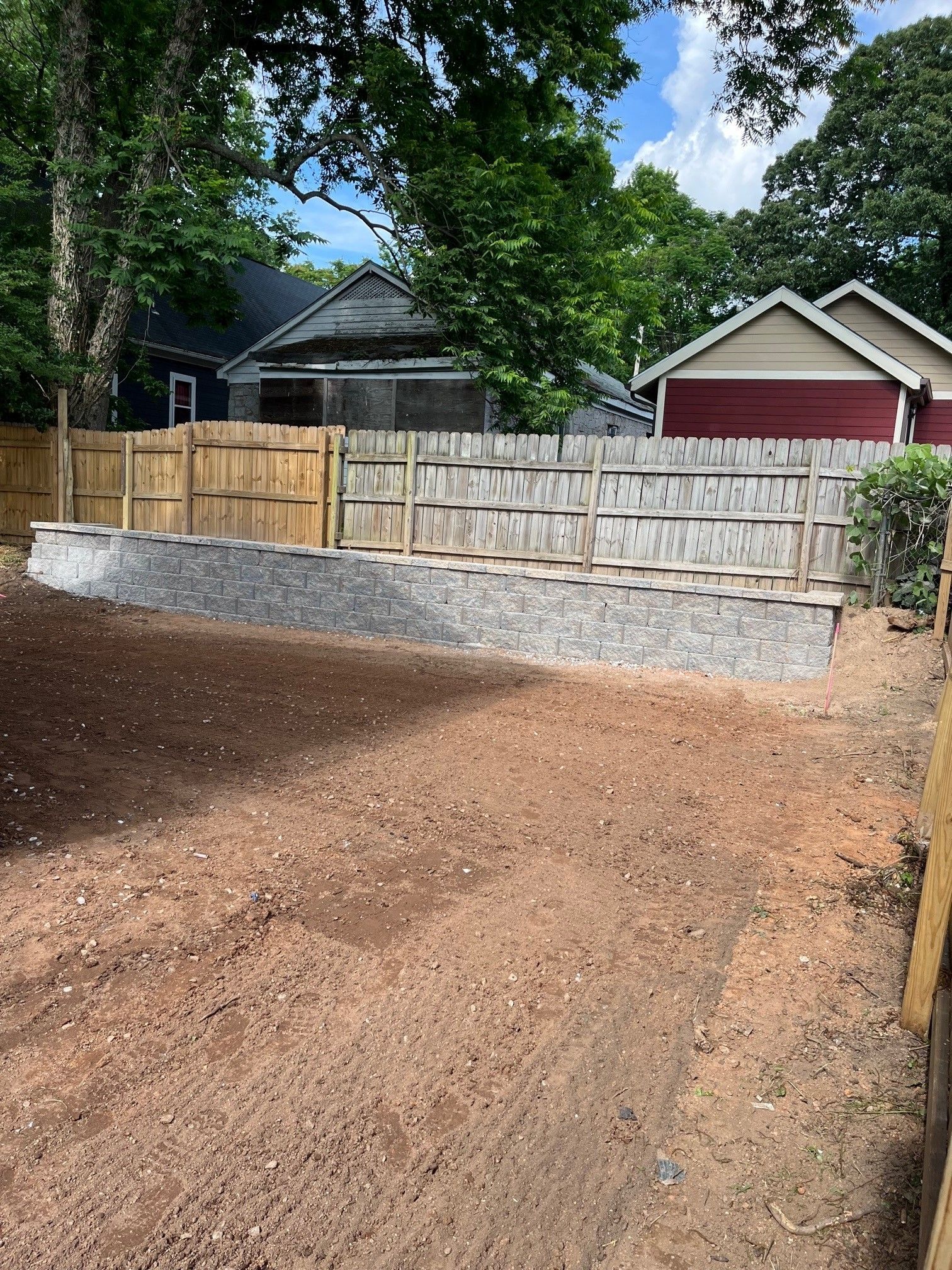 A fence is being built in the backyard of a house.