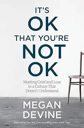 Book cover reading “It’s OK That You’re Not OK” by Megan Devine, with a chair on a gray background.
