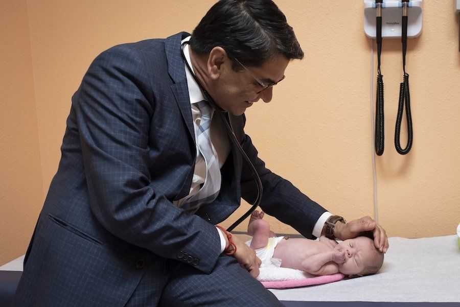 Pediatrician treating a child
