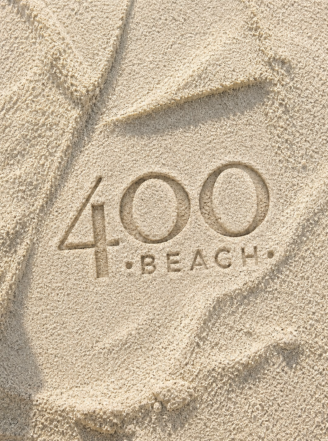 Embossed 40 Beach logo in tan sand with a small starfish-like shape above it